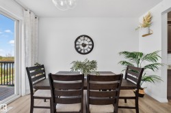 White walls, wood-finish flooring, and a sliding glass door providing natural illumination - 