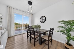 Wood-finish flooring, white walls, and a multi-bulb ceiling fixture - 