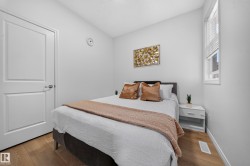 Neutral wall color, wood-finish flooring, white trim, and a window with blinds - 