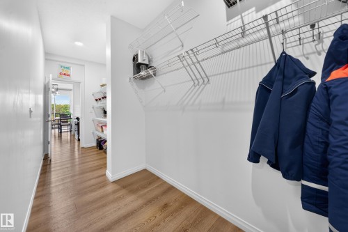 Wood-finish flooring throughout, white baseboards, and wire shelving storage system - 4104 3 Avenue Sw, Edmonton, AB 