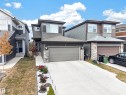 Contemporary exterior with multi-level siding, stone veneer accents, and an attached two-car garage - 4104 3 Avenue Sw, Edmonton, AB 