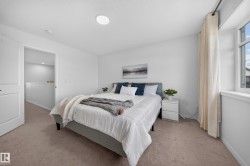 Recessed ceiling lighting, a window with drapery, and neutral carpeting - 