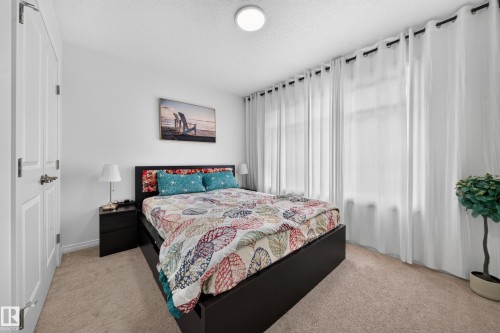 Textured carpet flooring, white painted walls, and ceiling-mounted light fixture - 4104 3 Avenue Sw, Edmonton, AB 