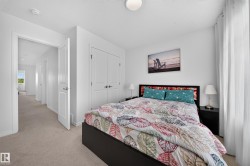 White interior walls, neutral carpet flooring, recessed ceiling lighting, and a double-door closet - 