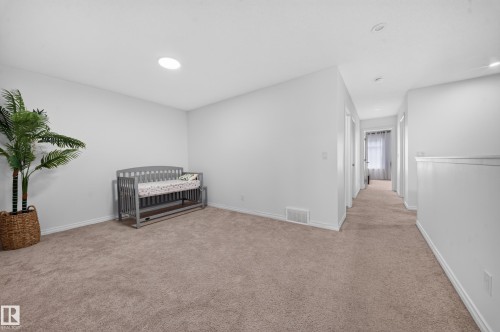 Carpeted room with white walls, recessed lighting, and a solar tube skylight - 4104 3 Avenue Sw, Edmonton, AB 