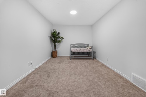 Neutral wall tones with plush carpet flooring and a recessed ceiling light - 4104 3 Avenue Sw, Edmonton, AB 