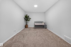 Neutral wall tones with plush carpet flooring and a recessed ceiling light - 