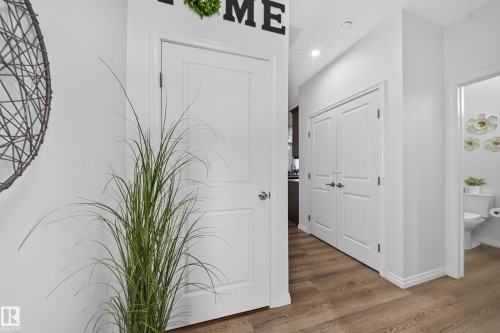 Wood-finish flooring throughout, bright white walls, and recessed lighting - 4104 3 Avenue Sw, Edmonton, AB 