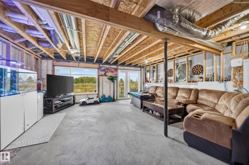 Unfinished basement space with exposed ceiling joists, concrete flooring, and multiple egress windows - 4104 3 Avenue Sw, Edmonton, AB 