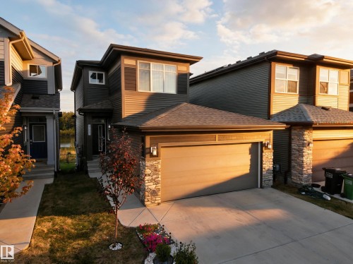Modern two-story residence with a multi-textured facade including horizontal siding and stone accents - 4104 3 Avenue Sw, Edmonton, AB 