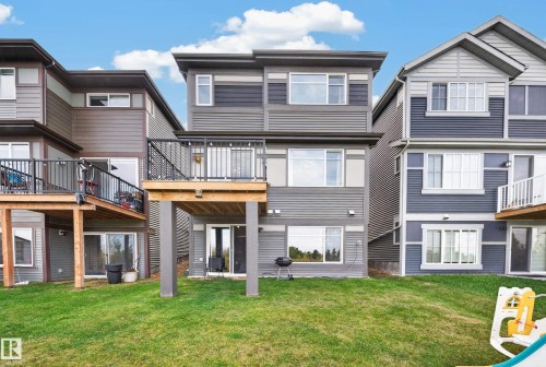 Three-story exterior with horizontal siding, upper-level balcony, and ground-level patio access - 4104 3 Avenue Sw, Edmonton, AB 