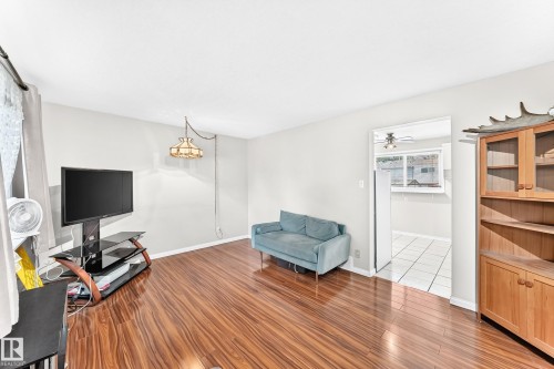 Wood-finish flooring throughout the main living space - 44 Habitat Crescent Nw, Edmonton, AB 