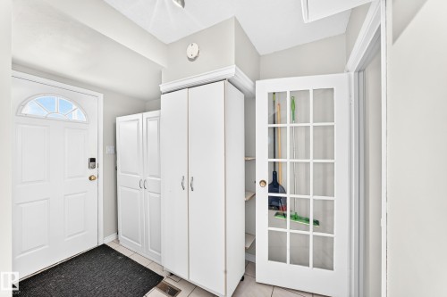 White entry door with an arched transom window - 44 Habitat Crescent Nw, Edmonton, AB 