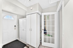 White entry door with an arched transom window - 