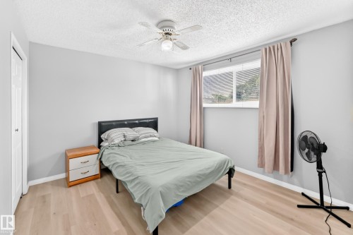 Light wood-finish flooring, a ceiling fan, and a double-pane window - 44 Habitat Crescent Nw, Edmonton, AB 