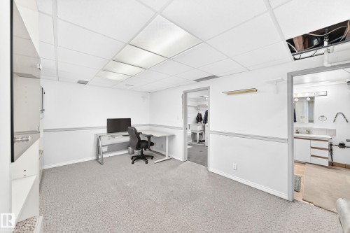 Carpeted room with drop ceiling, white walls, and built-in shelving - 44 Habitat Crescent Nw, Edmonton, AB 