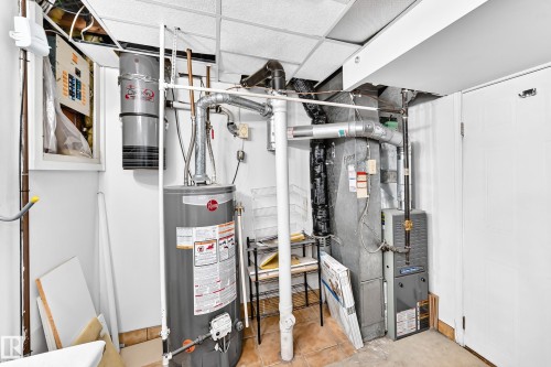 Utility space featuring a water heater, furnace, and central vacuum system - 44 Habitat Crescent Nw, Edmonton, AB 