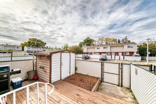 Exterior deck with a storage shed, chain link fencing, and a gravel area - 44 Habitat Crescent Nw, Edmonton, AB 