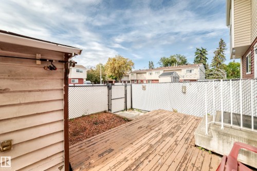 Wood deck surface, white chain link fencing, a gate, and a wood-sided structure - 44 Habitat Crescent Nw, Edmonton, AB 