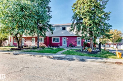 Two-story exterior with red siding and light grey upper level - 44 Habitat Crescent Nw, Edmonton, AB 