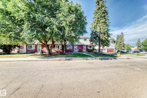Red-sided exterior with white trim windows and a white front door - 44 Habitat Crescent Nw, Edmonton, AB 
