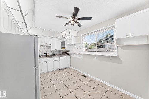White cabinetry, tile flooring, ceiling fan, and a window with blinds - 44 Habitat Crescent Nw, Edmonton, AB 