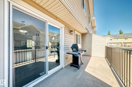 Exterior patio featuring a concrete surface, metal railing, and vinyl siding - #39 7289 South Terwillegar Nw, Edmonton, AB 