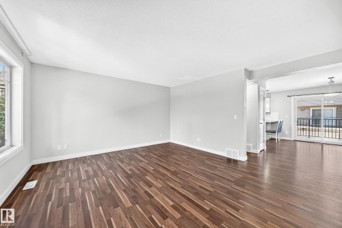 Wood-finish flooring, ample natural light, neutral wall colors, and an open concept layout - #39 7289 South Terwillegar Nw, Edmonton, AB 