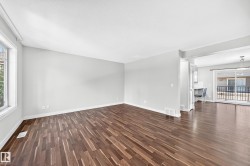 Wood-finish flooring, ample natural light, neutral wall colors, and an open concept layout - 
