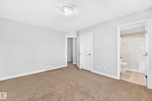 Neutral-toned carpeting, white trim, and a flush mount ceiling light fixture - #39 7289 South Terwillegar Nw, Edmonton, AB 