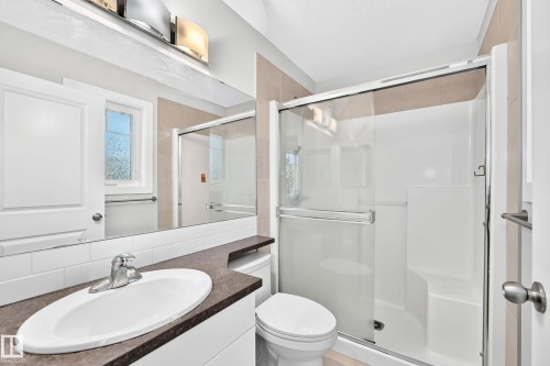 White oval basin with a chrome faucet set within a dark-toned countertop - #39 7289 South Terwillegar Nw, Edmonton, AB 