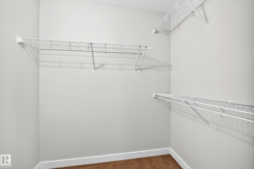 Interior closet featuring wire shelving and wood-finish flooring - #39 7289 South Terwillegar Nw, Edmonton, AB 