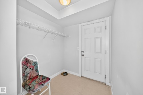 Recessed ceiling lighting, white wire shelving, paneled door, and neutral-toned floor tile - #39 7289 South Terwillegar Nw, Edmonton, AB 