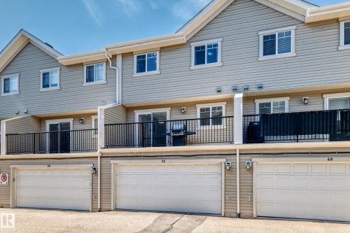 Two-story townhouse exterior with horizontal siding and multiple windows - #39 7289 South Terwillegar Nw, Edmonton, AB 