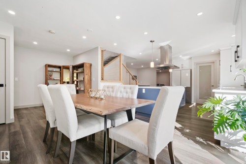 Open concept living space featuring wood-finish flooring, recessed lighting, and a modern kitchen with a large central island - 49279 Rge Rd 240, Rural Leduc County, AB 
