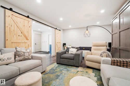 Wood-finish flooring, recessed lighting, and a built-in wall unit - 49279 Rge Rd 240, Rural Leduc County, AB 