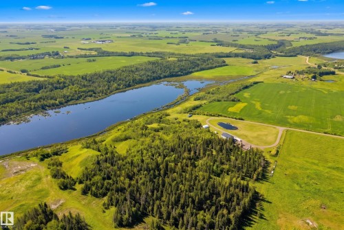 Expansive acreage featuring a private pond, mature tree line, and substantial open fields - 49279 Rge Rd 240, Rural Leduc County, AB 