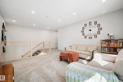 Recessed ceiling lighting, light gray wall paint, light-toned wood and cable railing, and gray carpet flooring - 49279 Rge Rd 240, Rural Leduc County, AB 