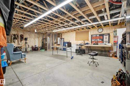 Exposed ceiling joists, concrete flooring, wood-paneled accent wall, and perimeter wall insulation - 49279 Rge Rd 240, Rural Leduc County, AB 