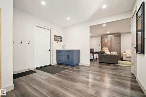 Recessed lighting illuminating wood-finish flooring - 49279 Rge Rd 240, Rural Leduc County, AB 