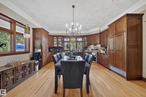 Hardwood flooring, wood-finish cabinetry, built-in appliances, recessed lighting, and crown molding - 719 65 Ave Nw, Edmonton, AB 