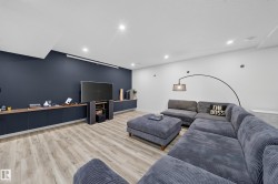 Recessed lighting, wood-finish flooring, and built-in cabinetry with a wood-finish countertop - 