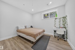 Recessed lighting, wood-finish flooring, and a window with white trim - 