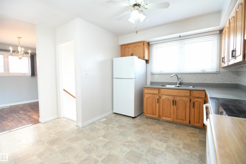 Lots of floorspace in the oak kitchen gives ample elbow room for everyone to help out or hang out.  The owners loved this family home, and even added a second stove in the garage, and a 2nd fridge and freezer downstairs, perfect for holiday dinners. - 10243 42 Street Nw, Edmonton, AB 