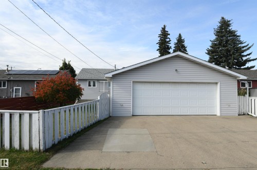 The garage is oversized, insulated, and has a new Reznor heater installed.  Full driveway in front of the garage is great for additional parking or projects, and the 220V plug in the garage is perfect for anyone with hobby or tool needs, or an EV charger - 10243 42 Street Nw, Edmonton, AB 