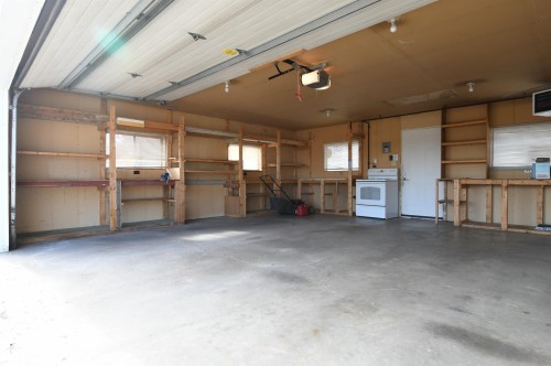 The garage is oversized, insulated, and has a new Reznor heater installed.  Full driveway in front of the garage is great for additional parking or projects, and the 220V plug in the garage is perfect for anyone with hobby or tool needs, or an EV charger - 10243 42 Street Nw, Edmonton, AB 