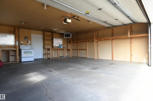 The garage is oversized, insulated, and has a new Reznor heater installed.  Full driveway in front of the garage is great for additional parking or projects, and the 220V plug in the garage is perfect for anyone with hobby or tool needs, or an EV charger - 10243 42 Street Nw, Edmonton, AB 