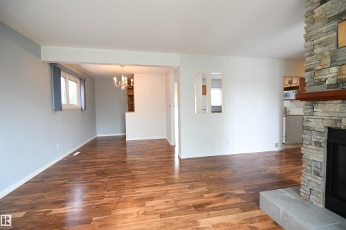 The dining area has built in storage cabinetry, and the kitchen wall has even been opened up to keep the family connected - 10243 42 Street Nw, Edmonton, AB 