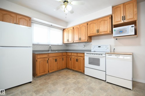 Lots of floorspace in the oak kitchen gives ample elbow room for everyone to help out or hang out.  The owners loved this family home, and even added a second stove in the garage, and a 2nd fridge and freezer downstairs, perfect for holiday dinners. - 10243 42 Street Nw, Edmonton, AB 