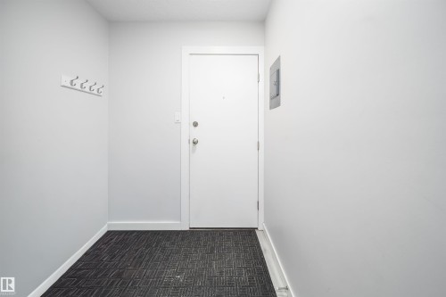 Entryway featuring white painted walls and patterned floor covering - #202 10615 156 St Nw, Edmonton, AB 